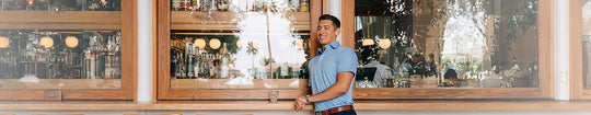 man in dress collar polo blue houndstooth at bar restaurant arizona
