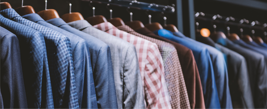 various men's suit jackets hung up