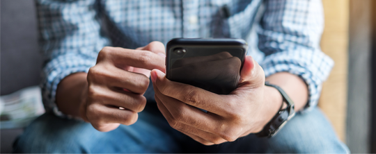 man scrolling on his cell phone