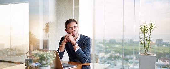 man sitting in an office looking out his window